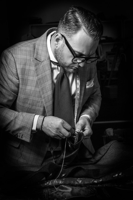 Grant van Den Berg tailoring a garment